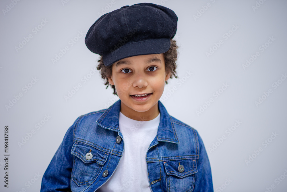 cute Lovely dark-skinned boy with age 6 years in different clothes shows different emotions on different backgrounds cute Lovely dark-skinned boy with age 6 years in different clothes shows different emotions on different backgrounds