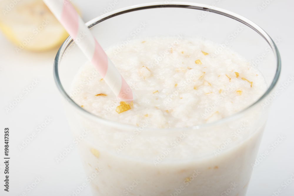 Healthy eating,diet smoothie drink is made from natural pear and banana with a straw on a white wooden background Healthy eating,diet smoothie drink is made from natural pear and banana with a straw on a white wooden background