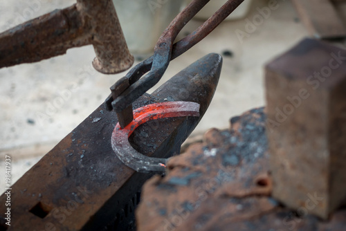 Making the horseshoe from heated red rod.