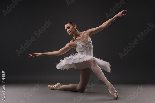 Beautiful ballerina in a gracefull pose in the dark