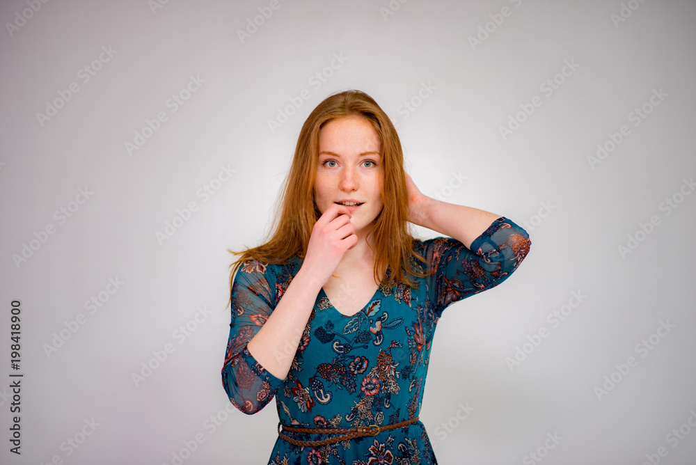 Cute beautiful red-haired girl shows different emotions in different poses on different background in different clothes Cute beautiful red-haired girl shows different emotions in different poses on different background in different clothes