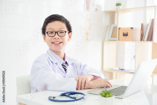Young asian boy pretend to be a doctor in hospital