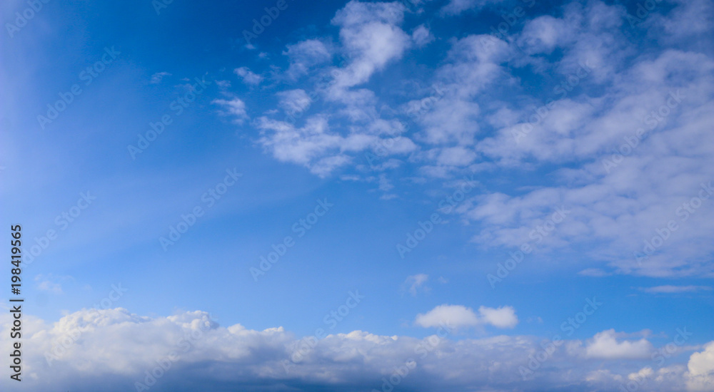Spring. blue sky with fluffy white clouds. sun, sunlight, clouds, sky - spring changeable weather.