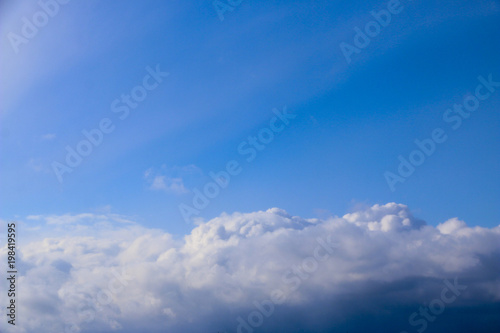 Spring. blue sky with fluffy white clouds. sun, sunlight, clouds, sky - spring changeable weather.