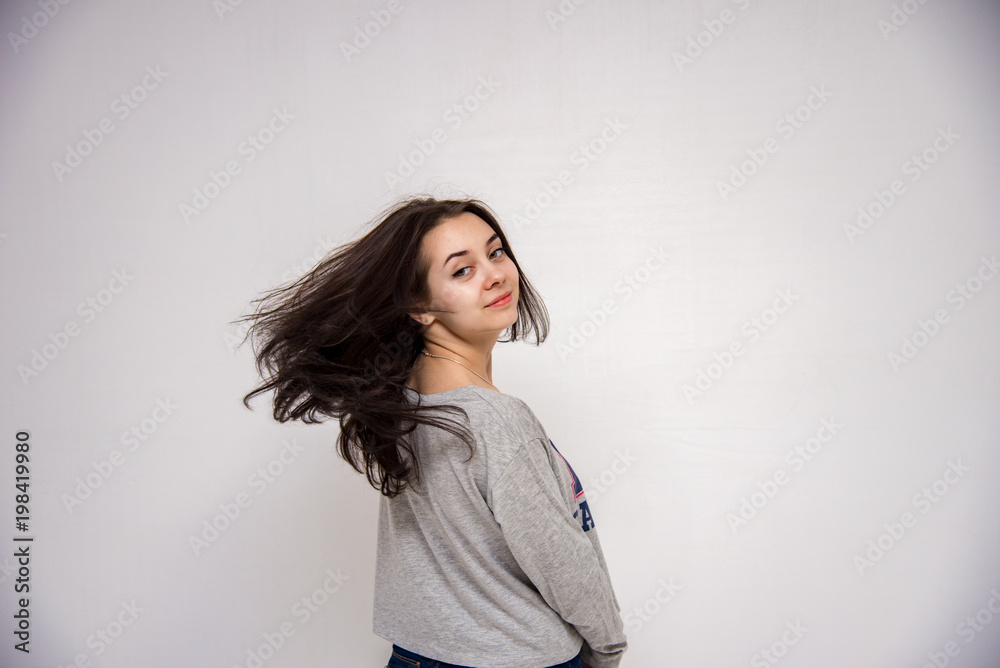 Cute brunette beautiful girl in different poses shows different emotions on different backgrounds in different clothes Cute brunette beautiful girl in different poses shows different emotions on different backgrounds in different clothes