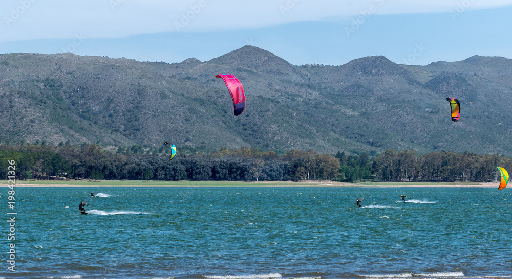 kite surfing on lake with mountains
