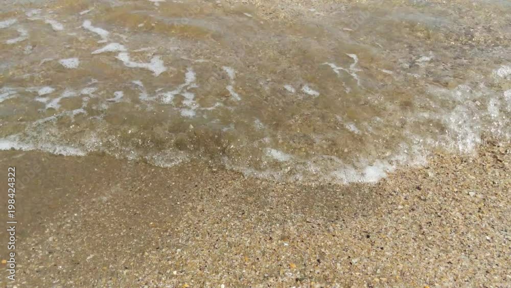 Surf and small waves on the beach
