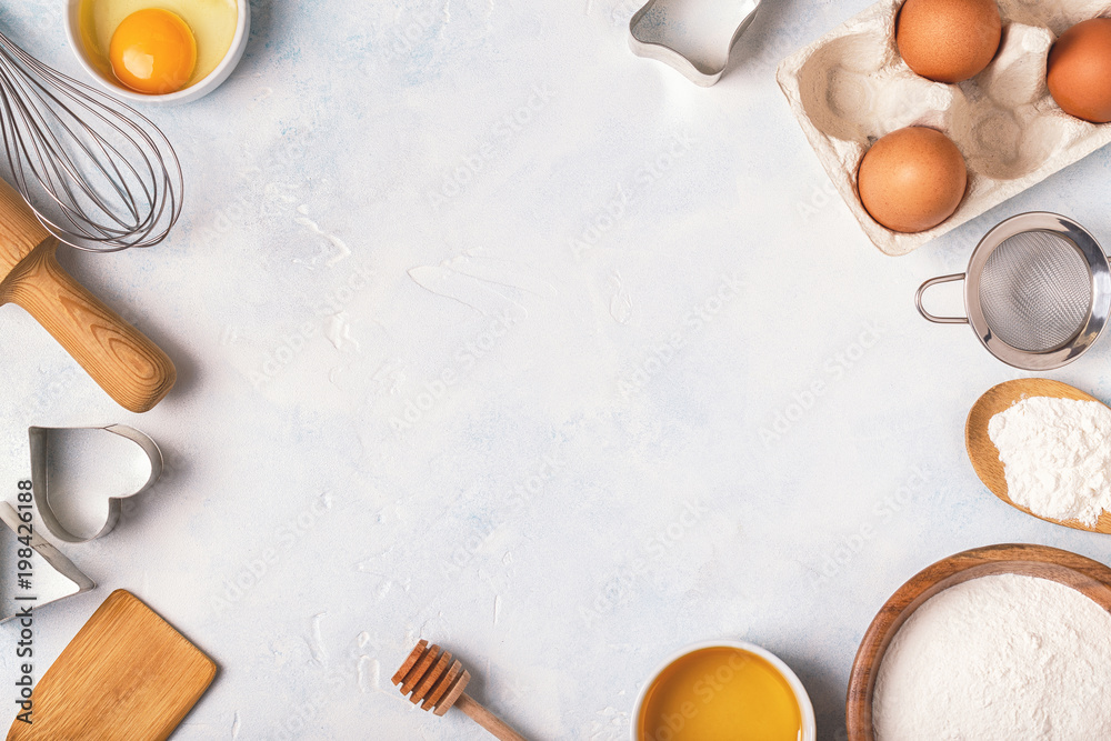 Ingredients for baking  - flour, wooden spoon, eggs.