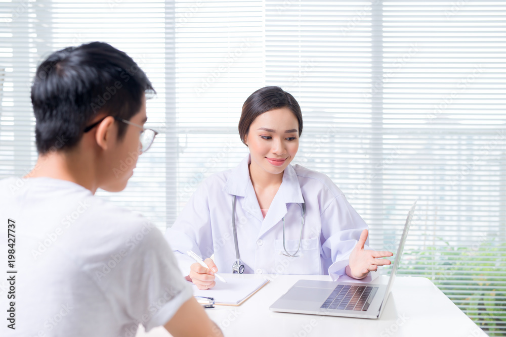 Friendly female doctor hands holding patient hand sitting at the desk Friendly female doctor hands holding patient hand sitting at the desk