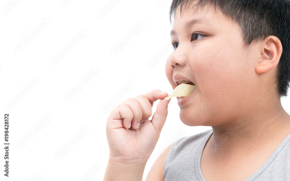 Obese fat boy eating potato chips isolated Obese fat boy eating potato chips isolated