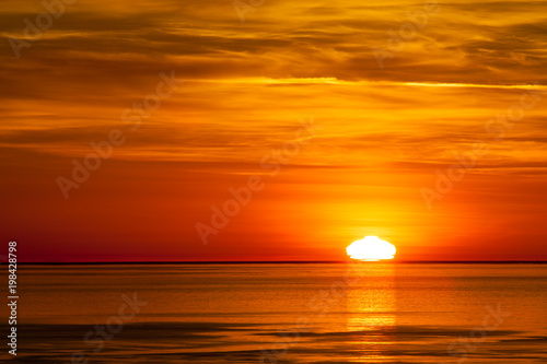 The sun setting in the pacific ocean in Washington State, USA