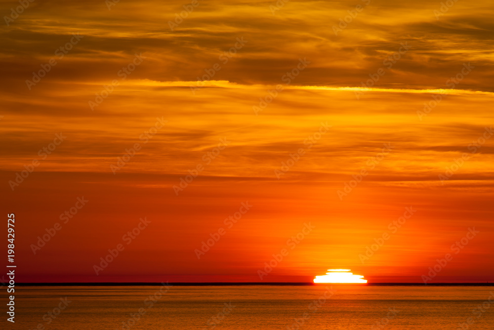 The sun setting in the pacific ocean in Washington State, USA