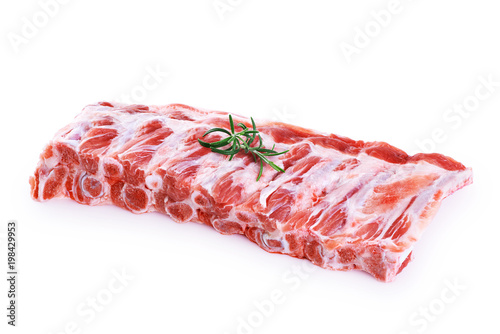 Raw fresh pork ribs and rosemary isolated on white background.