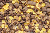 background of mixed breakfast cereal (chocolate balls, corn, grain, chocolate pads), top view