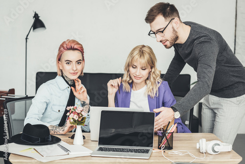 portrait of group of creative workers discussing new idea at workplace in office photo