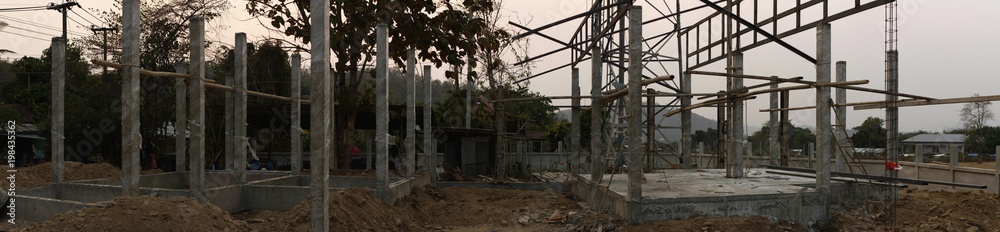 panoramic picture of a housing estate being constructed using concrete pillars and foundations in Southeast Asia