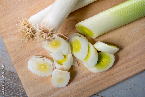 leeks cut into slices on wooden plank