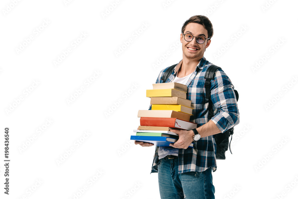 smiling handsome student holding stack of books isolated on white smiling handsome student holding stack of books isolated on white