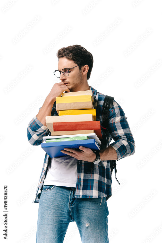 pensive handsome student holding stack of books isolated on white pensive handsome student holding stack of books isolated on white