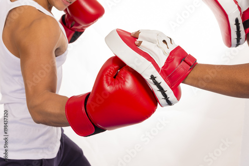 Close up of boxing workout action in fitness class on white background. photo