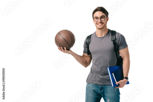 smiling handsome student holding basketball ball isolated on white © LIGHTFIELD STUDIOS