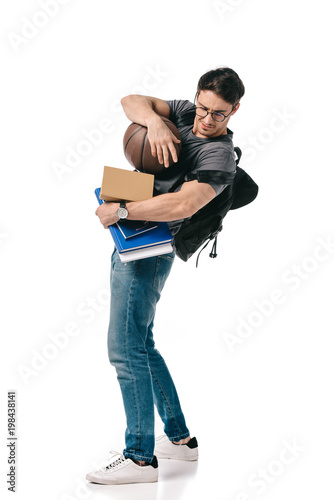 handsome student with books and basketball ball on white