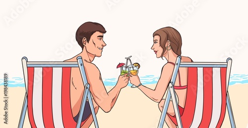 Man and woman sit in deck chairs on sandy beach in front of sea and clink gla...