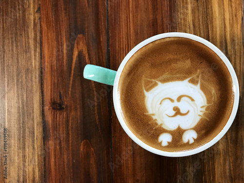 Cute cat face latte art coffee in white cup on wooden table ; love coffee, Cute Neko latte art coffee