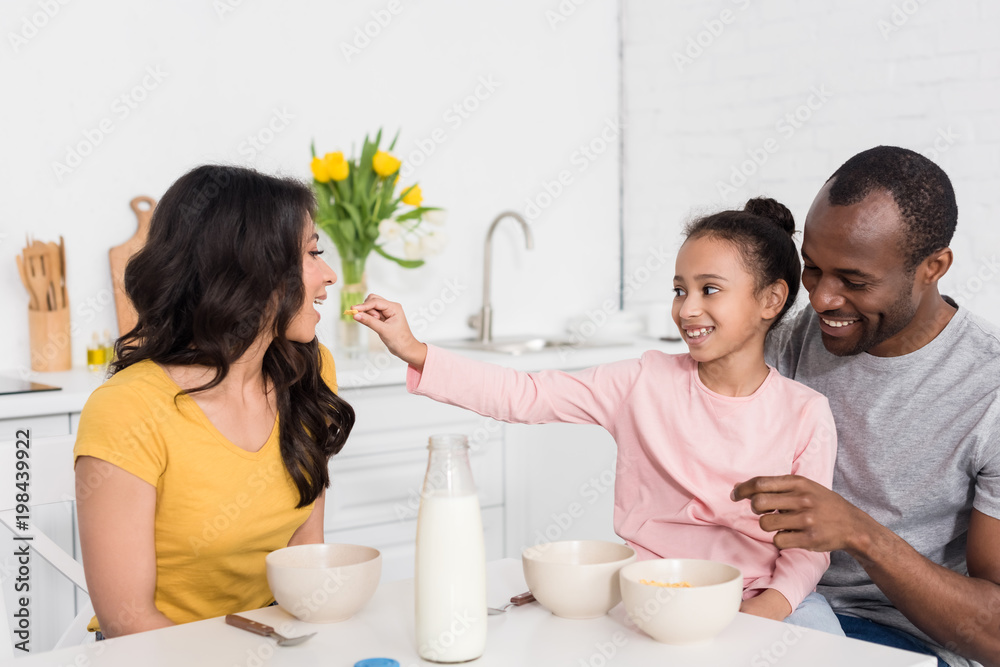 beautiful young family spending time on kitchen together beautiful young family spending time on kitchen together