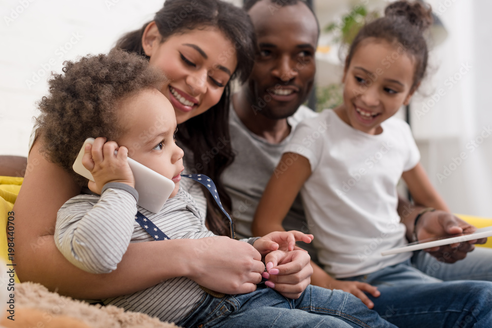happy young family spending time together with devices happy young family spending time together with devices