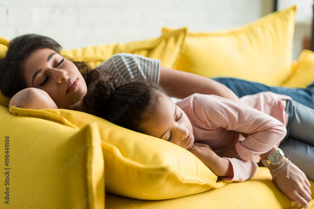 mother and daughter sleeping together on couch mother and daughter sleeping together on couch