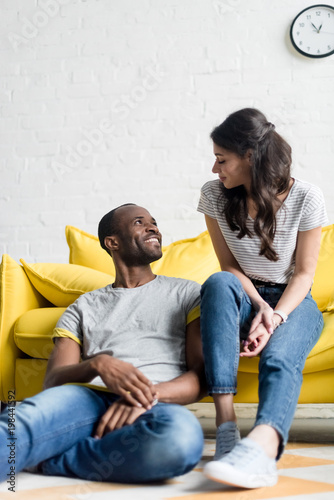 young african american couple spending time together at living room