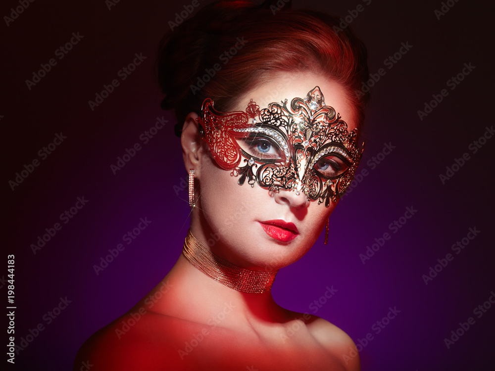 Beautiful young woman in mysterious colors Venetian mask. Fashion photo.  Holidays and celebrations Stock Photo - Alamy