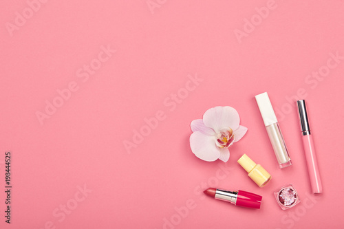 Fashionable Women's Cosmetics and Accessories. Falt Lay. Nail Polish and Lipstick. Beautiful Orchid Flower. Make Up Cosmetic items Top View