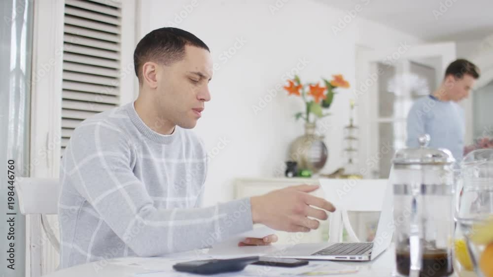 Young man going through accounts and realising financial problems Young man going through accounts and realising financial problems
