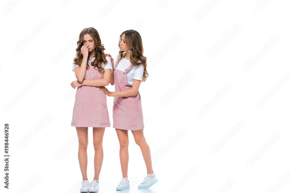 twin comforting sad sister isolated on white twin comforting sad sister isolated on white