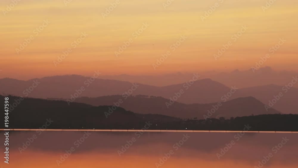 Smooth water surface in infinity pool and misty haze in sky over beautiful hills Smooth water surface in infinity pool and misty haze in sky over beautiful hills
