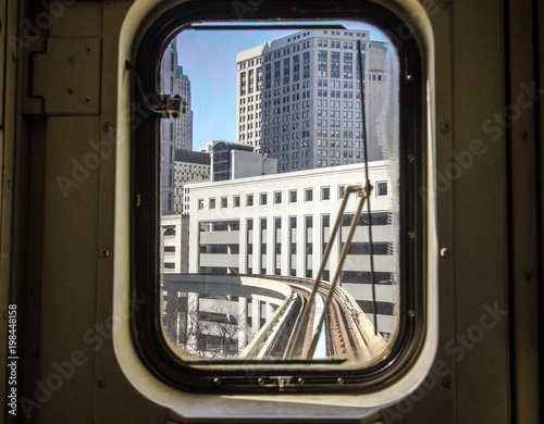 Morning Commute In The City. View through tram window of the city skyline and train tracks Detroit, Michigan.