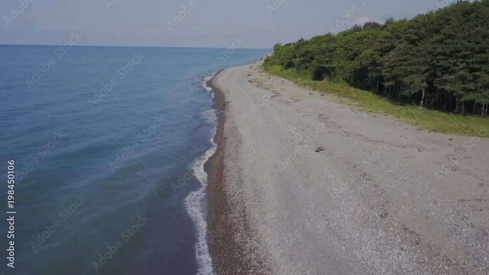 Flight over the wild beach. Mountains and cliffs Flight over the wild beach. Mountains and cliffs
