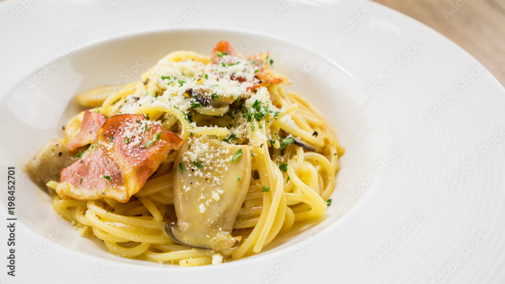 Spaghetti Carbonara.This recipe with Bacon Egg Mushroom Parmesan cheese and Spaghetti.Food styling on table. Spaghetti Carbonara.This recipe with Bacon Egg Mushroom Parmesan cheese and Spaghetti.Food styling on table.