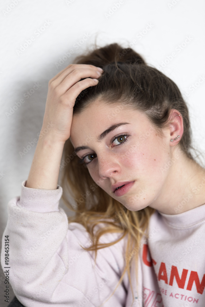 Young woman looking at camera with serious face. Vertical shot with natural light Young woman looking at camera with serious face. Vertical shot with natural light