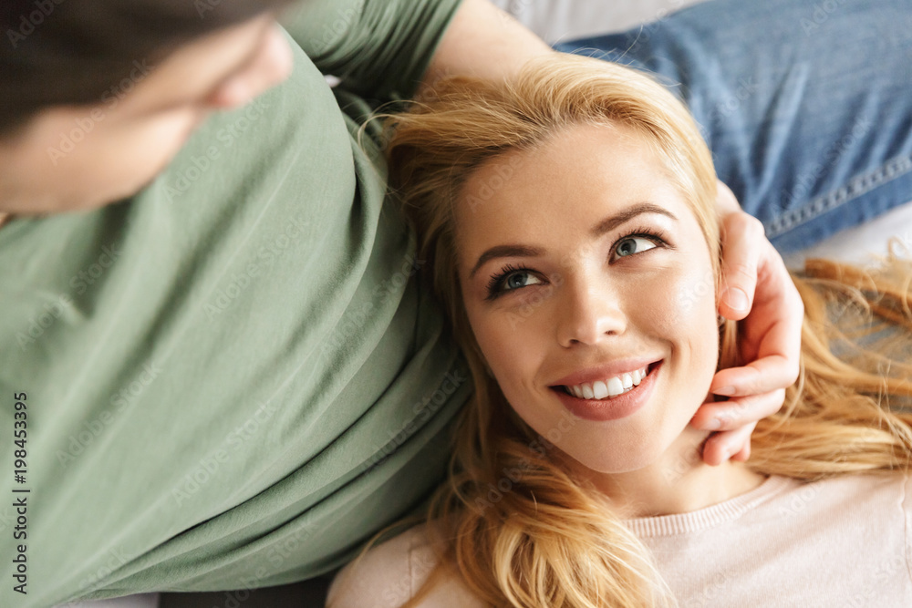 Cute smiling young woman lies on her husband StockFoto Adobe Stock