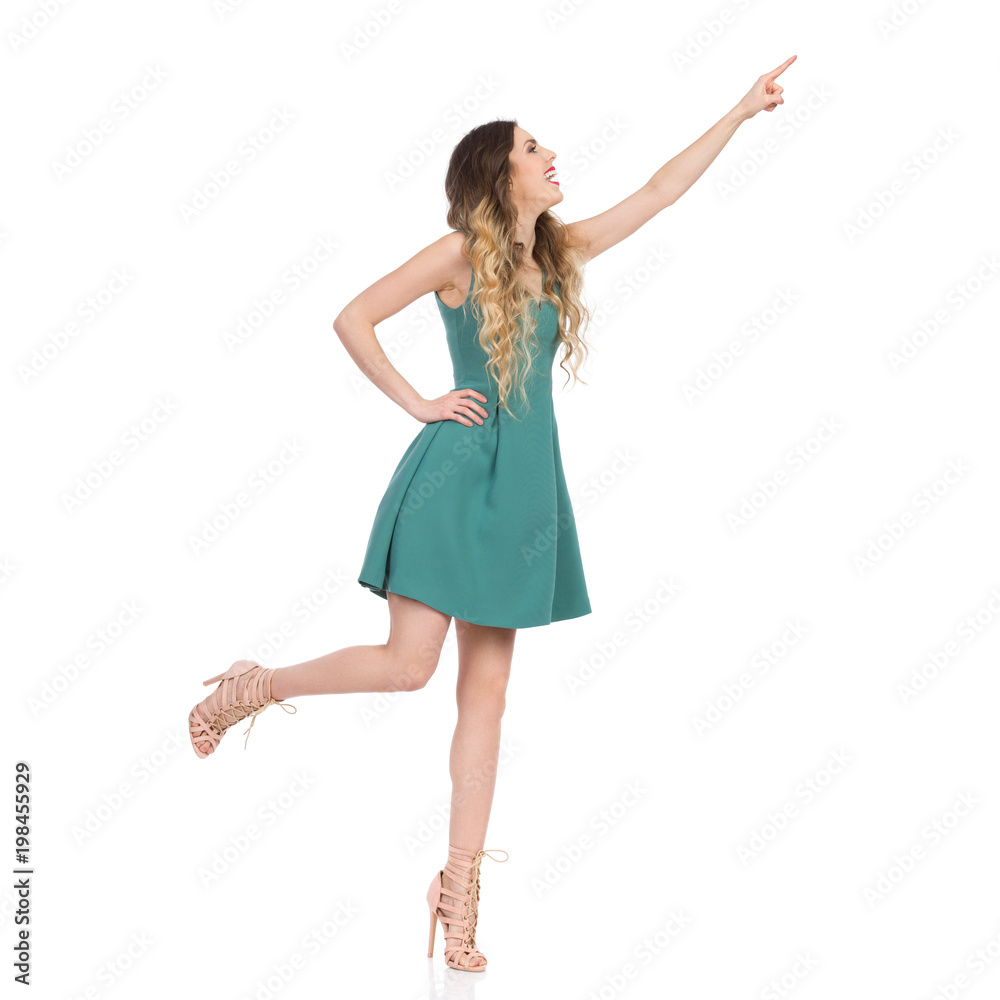 Elegant Woman In High Heels Is Standing On One Leg And Trying To Touch Something Elegant Woman In High Heels Is Standing On One Leg And Trying To Touch Something