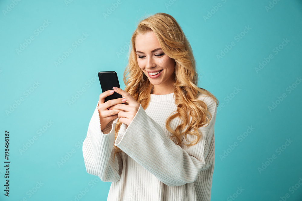 Portrait of a smiling young blonde woman in sweater Portrait of a smiling young blonde woman in sweater
