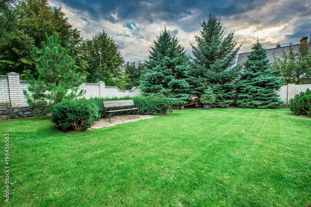 Wooden bench in a beautiful park garden. Wooden bench in a beautiful park garden.