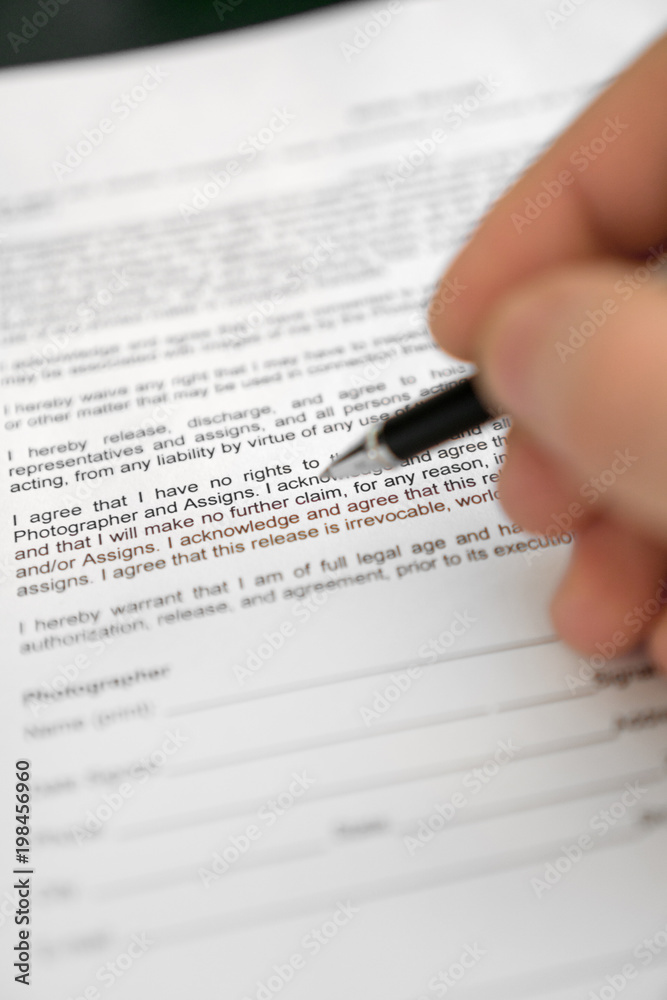Man is signing model release for microstock. Man is signing model release for microstock.