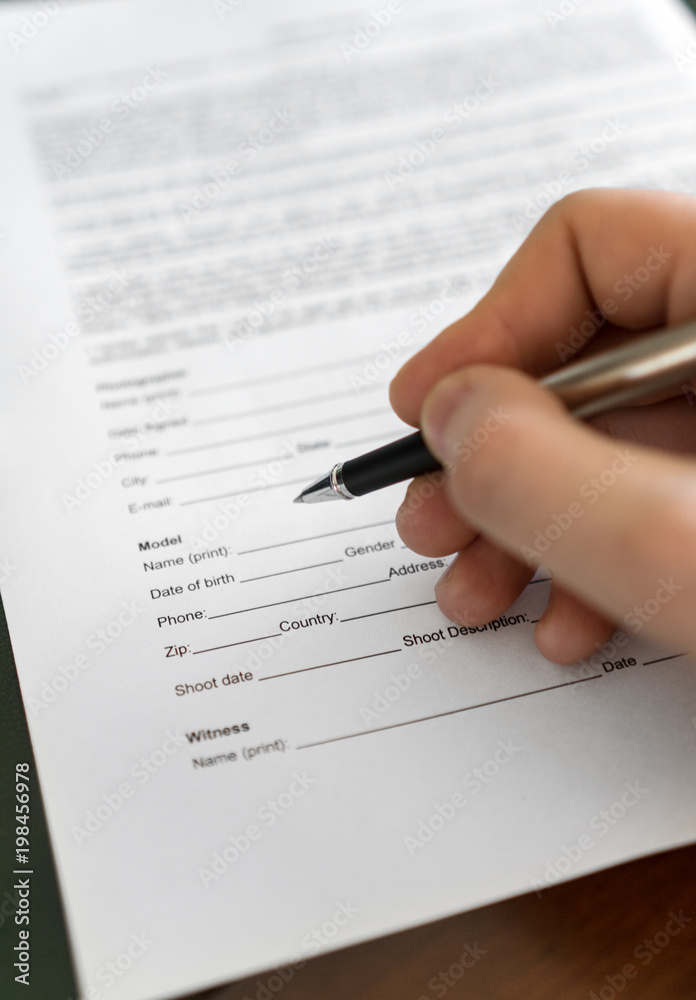 Man is signing model release for microstock. Man is signing model release for microstock.