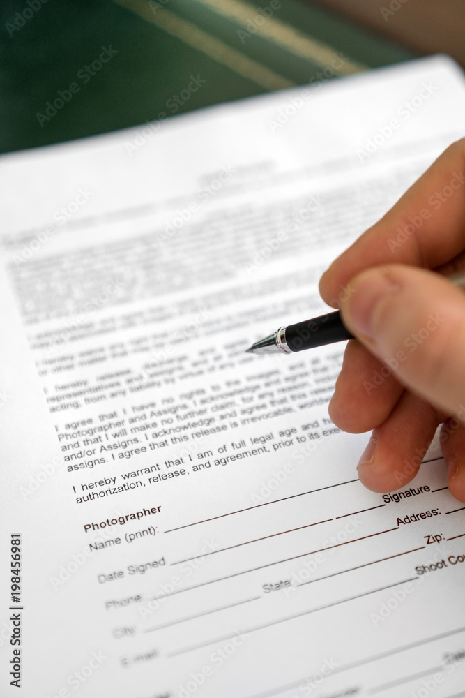 Man is signing model release for microstock. Man is signing model release for microstock.
