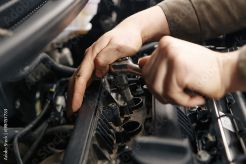 Professional mechanic checking car engine