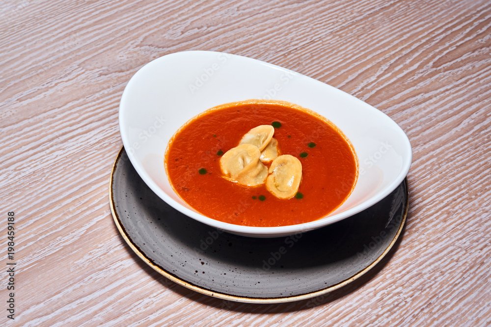 Plate with tomato cream in the restaurant. Plate with tomato cream in the restaurant.